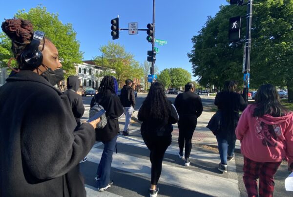 Image of youth gathering together walking the streets of DC, building community as part of the Youth Organizing Collective program.